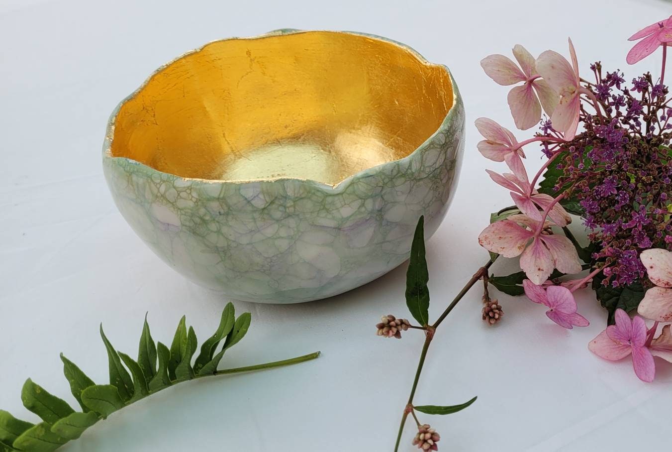 Large garden design glow bowl with rose gold gilding.