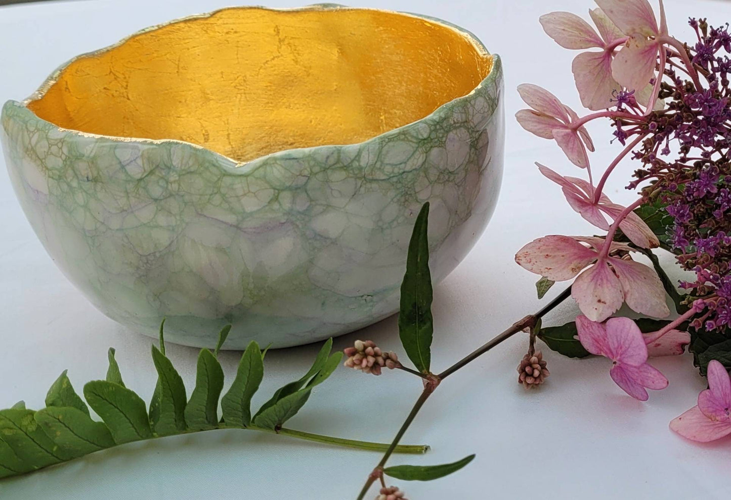 Large garden design glow bowl with rose gold gilding.